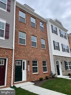 8804 Woodyard Station Road Clinton, MD 20735 - Photo 2 of 39 a front view of a house with a yard
