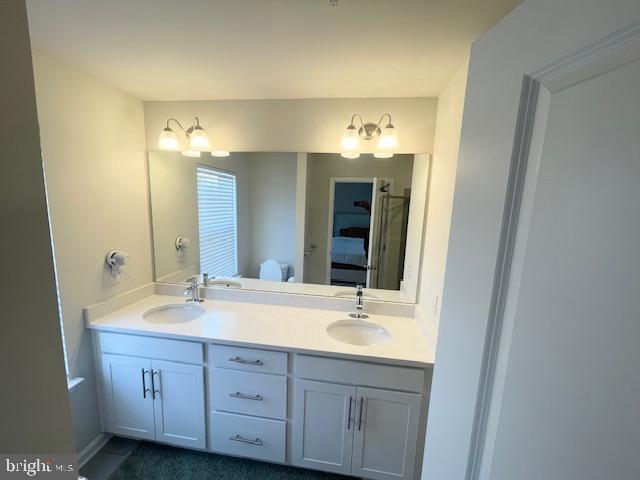 8804 Woodyard Station Road Clinton, MD 20735 - Photo 24 of 39 a bathroom with a double vanity sink and a mirror