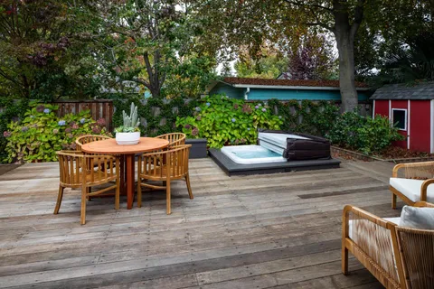 a backyard of a house with outdoor seating