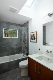 a bathroom with a double vanity sink toilet and shower