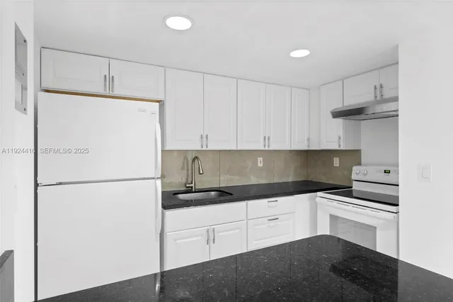 a white refrigerator freezer sitting in a kitchen
