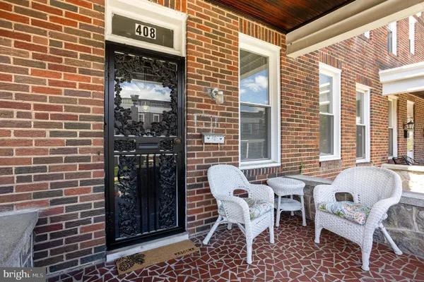a patio with table and chairs and potted plants
