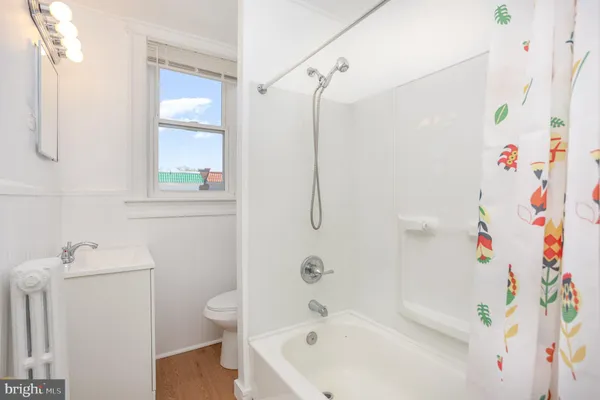 a bathroom with a bathtub and a shower curtain