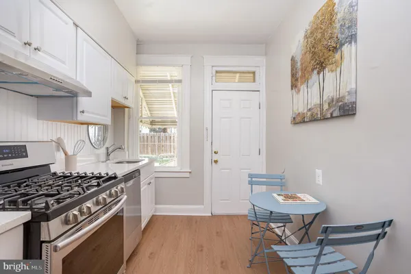 a kitchen with stainless steel appliances a stove a sink and a refrigerator