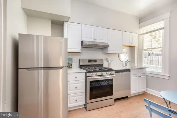 a white refrigerator freezer and a stove top oven