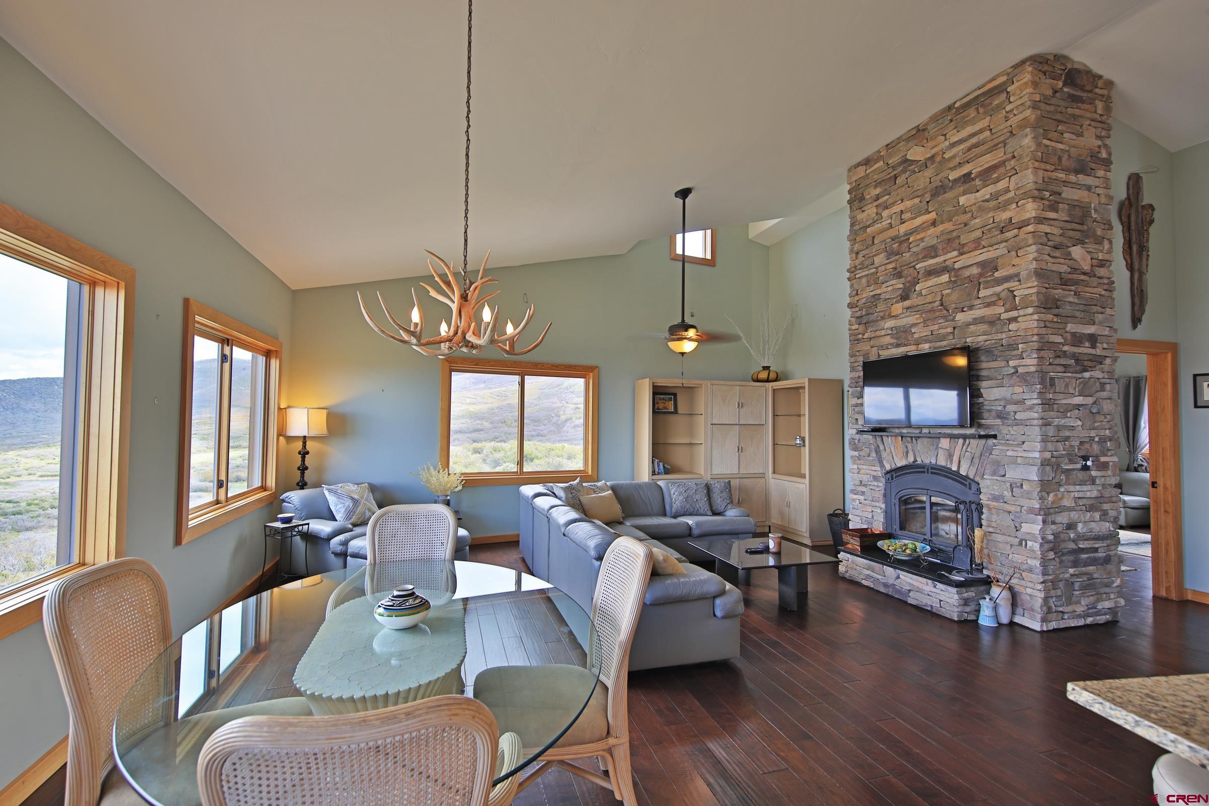 53315 Bull Basin Road Mesa, CO 81643 - Photo 16 of 44 a living room with fireplace furniture and a fireplace
