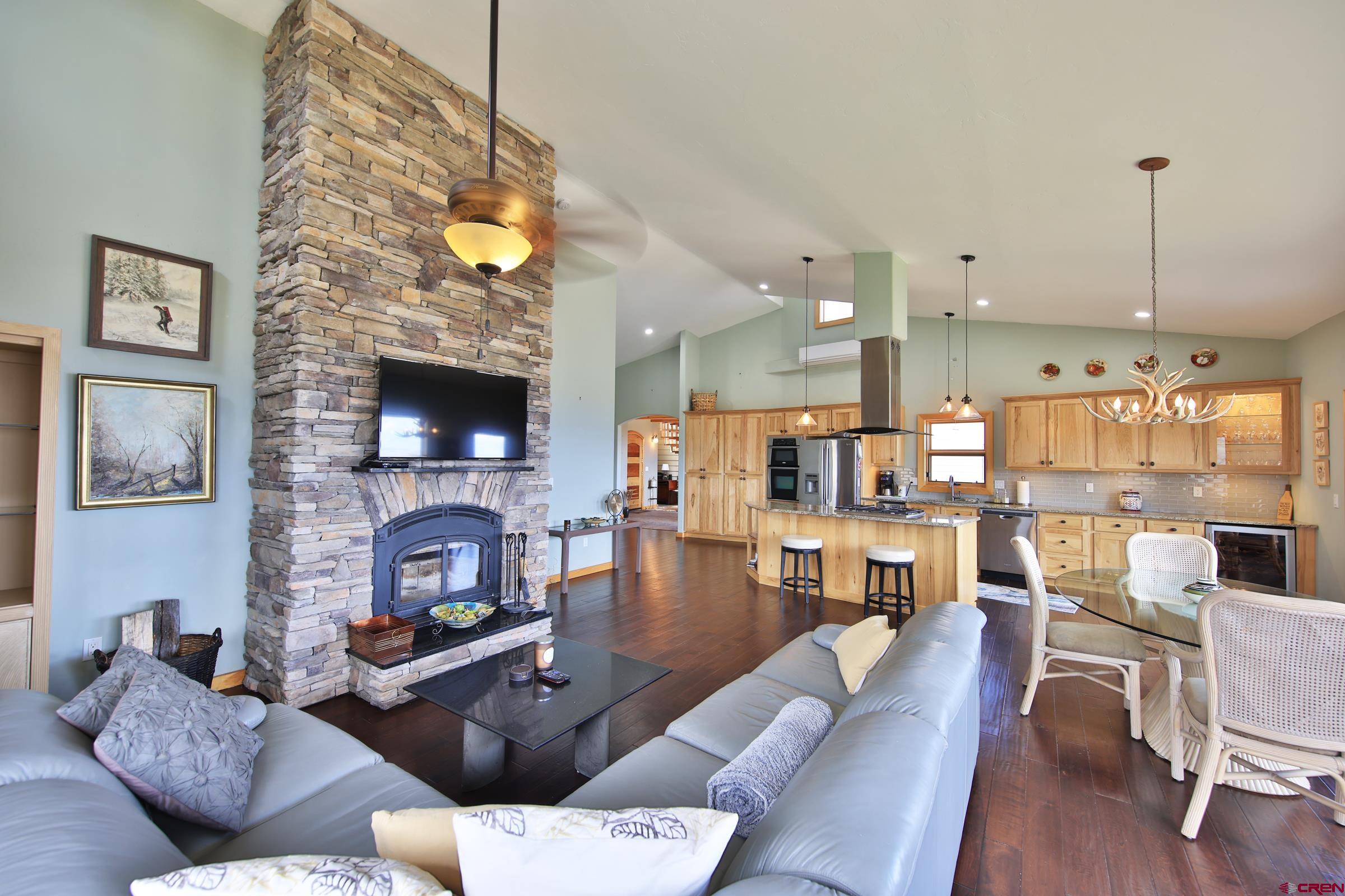 53315 Bull Basin Road Mesa, CO 81643 - Photo 18 of 44 a living room with fireplace furniture and a wooden floor
