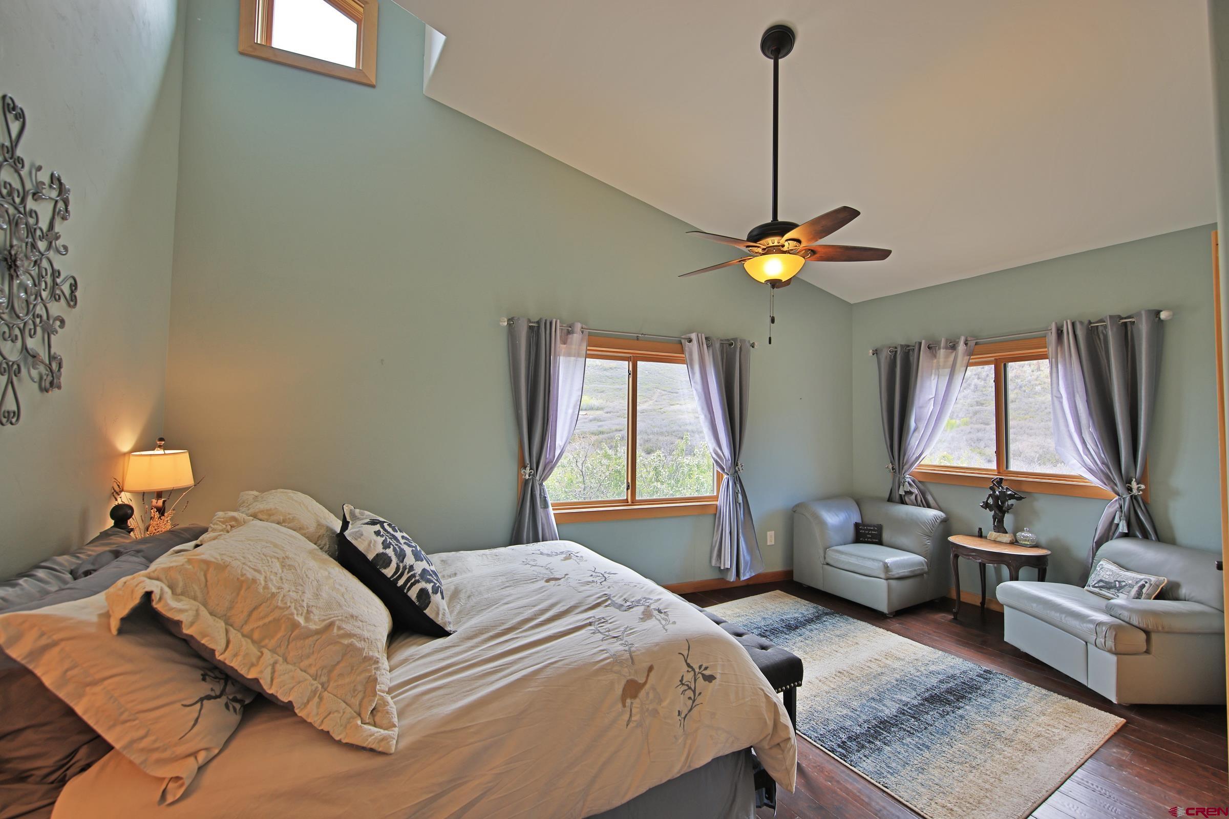 53315 Bull Basin Road Mesa, CO 81643 - Photo 19 of 44 a bedroom with a bed and a window