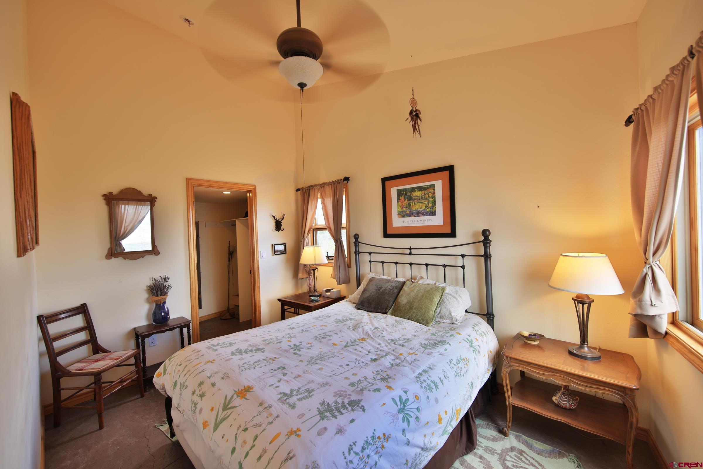 53315 Bull Basin Road Mesa, CO 81643 - Photo 25 of 44 a bedroom with a bed and a lamp