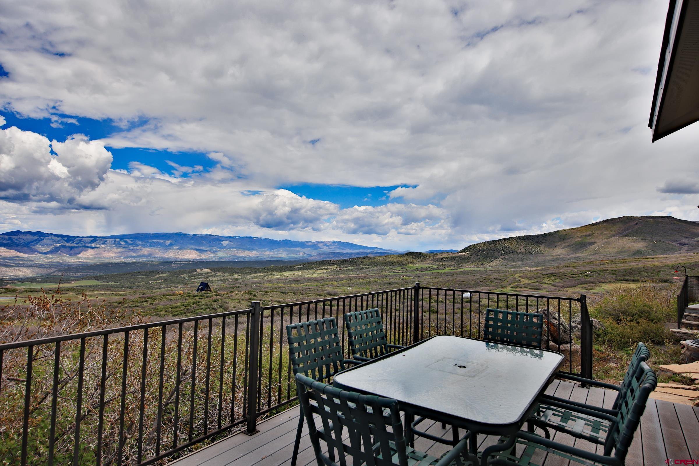 53315 Bull Basin Road Mesa, CO 81643 - Photo 27 of 44 a view of a balcony with a table