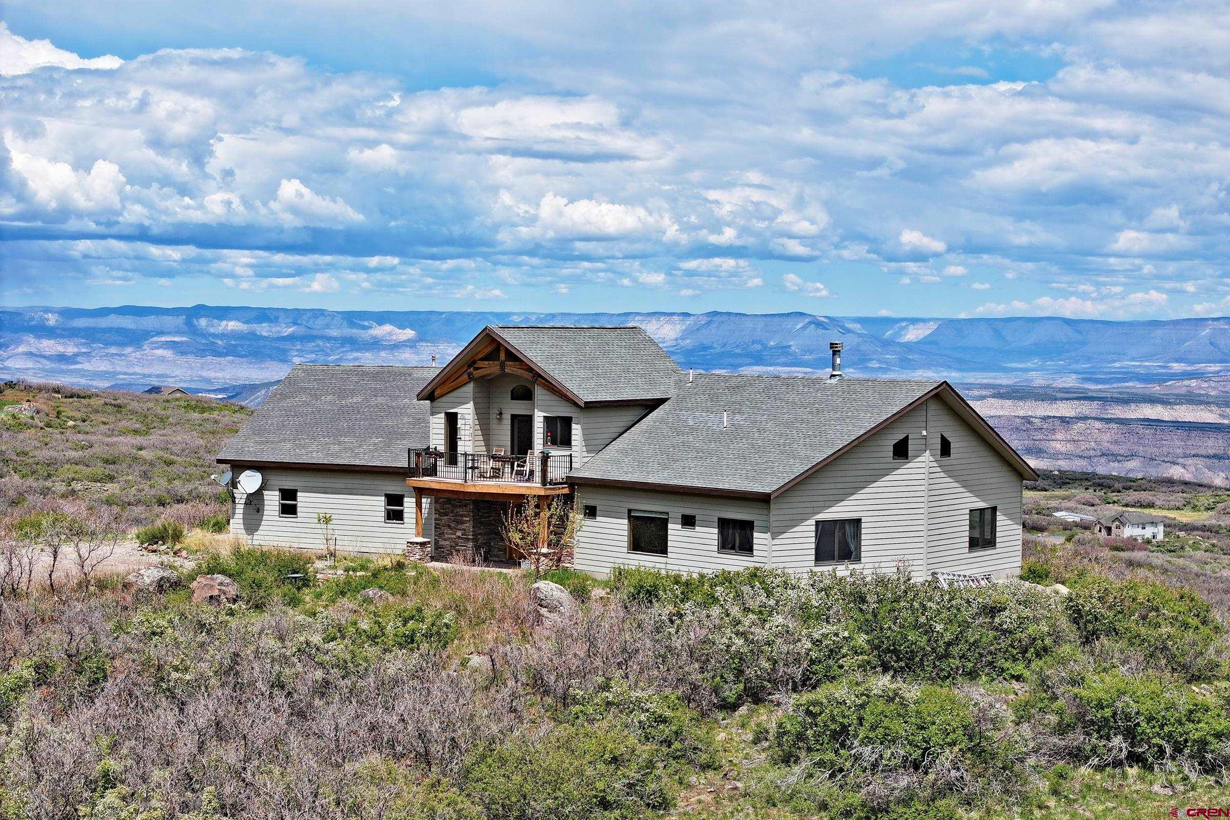 53315 Bull Basin Road Mesa, CO 81643 - Photo 3 of 44 a aerial view of a house with a yard and wooden fence
