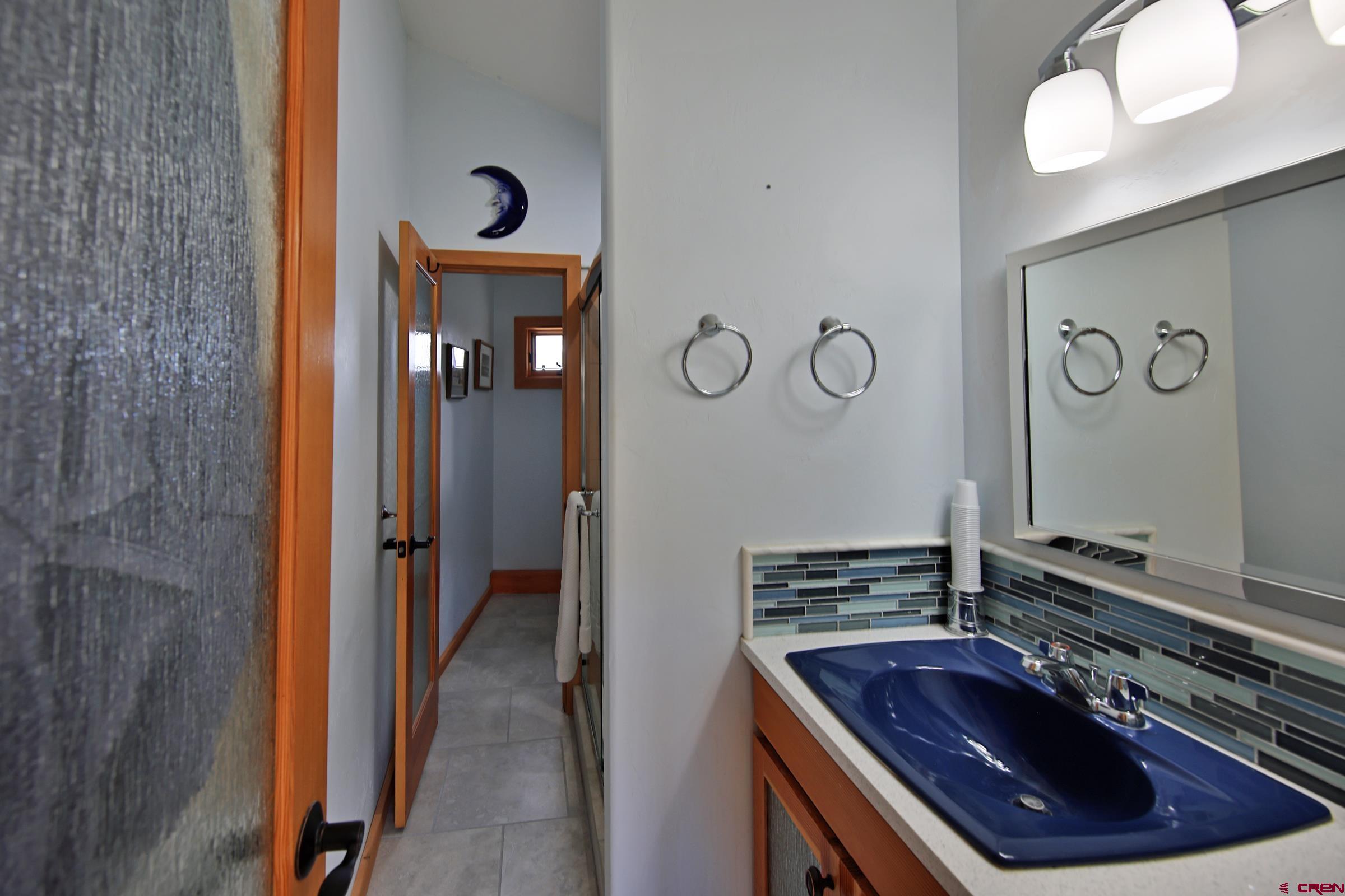 53315 Bull Basin Road Mesa, CO 81643 - Photo 34 of 44 a bathroom with a sink and a mirror