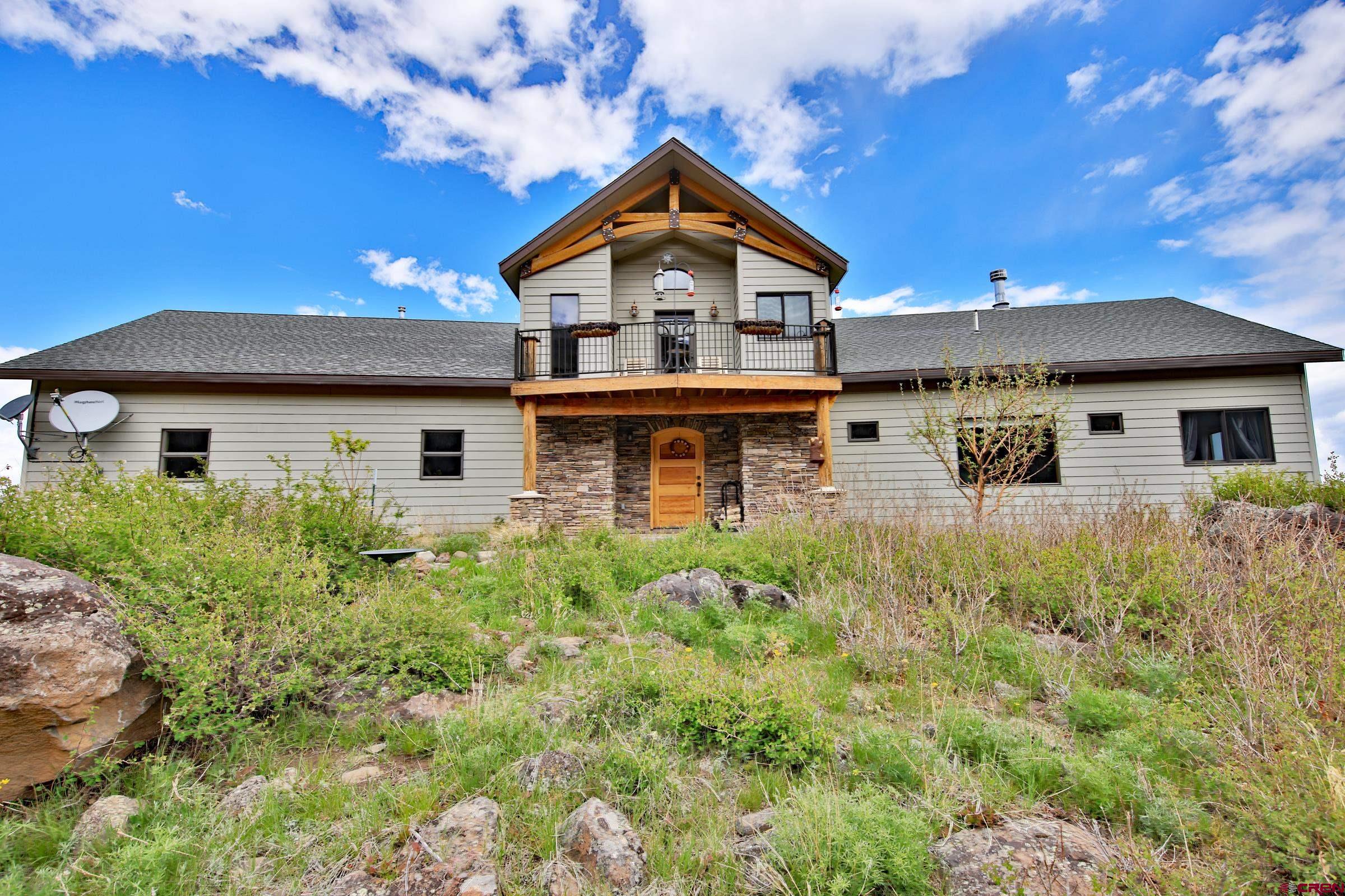 53315 Bull Basin Road Mesa, CO 81643 - Photo 5 of 44 a front view of a house with a garden