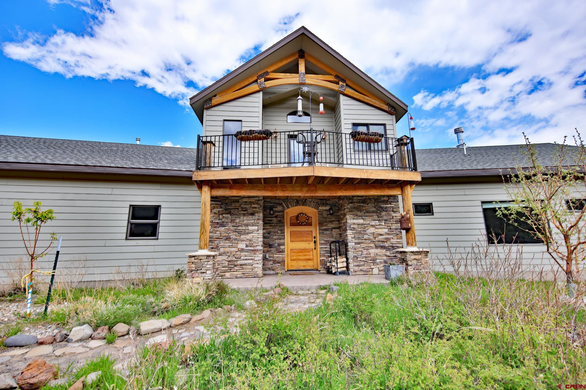 53315 Bull Basin Road Mesa, CO 81643 - Photo 6 of 44 a front view of a house with garage