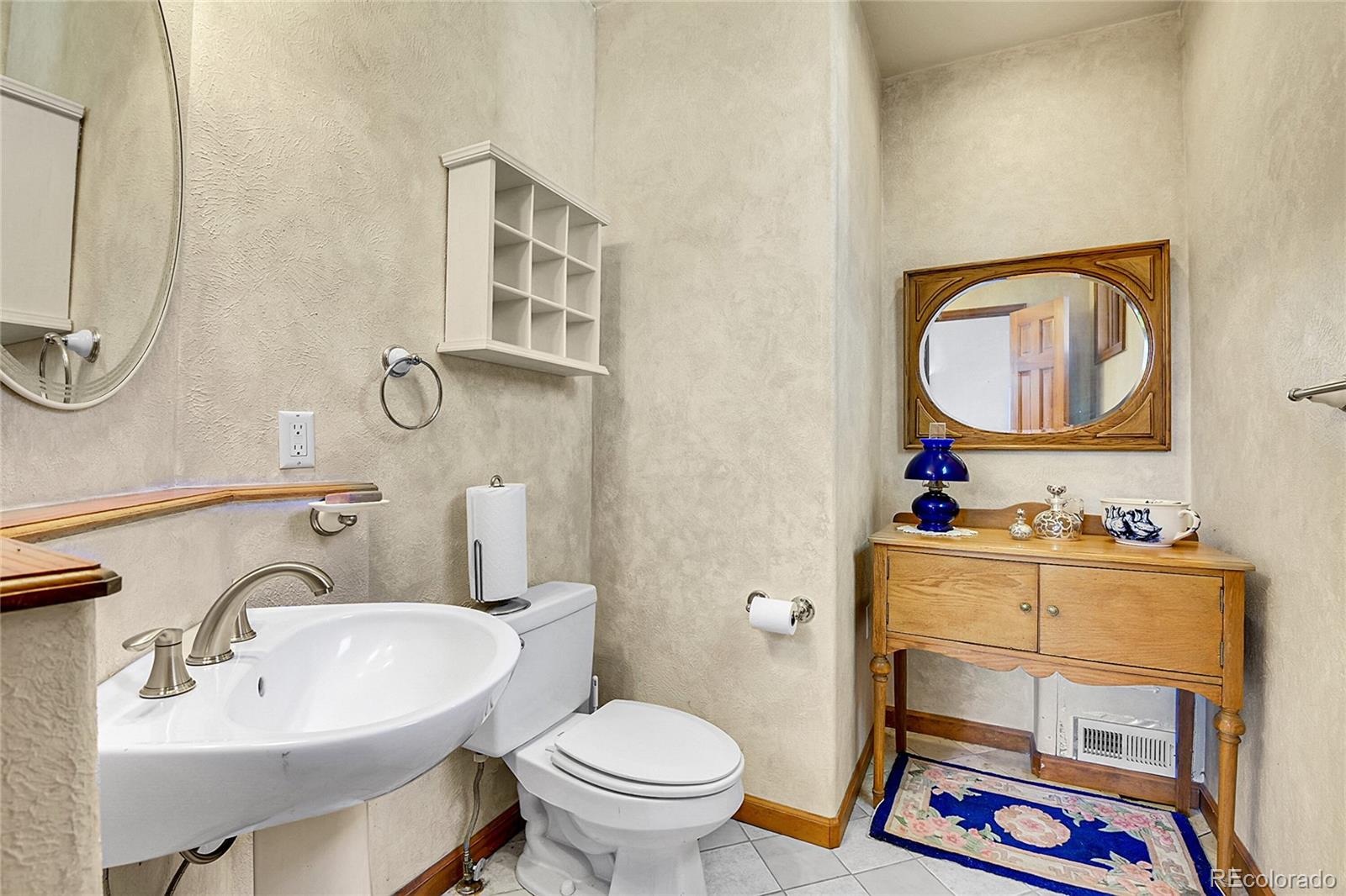 13082 South Wamblee Valley Road Conifer, CO 80433 - Photo 20 of 35 a bathroom with a sink toilet and mirror