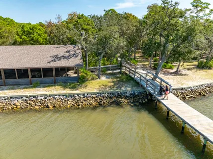 a view of a swimming pool with lawn chairs under an umbrella