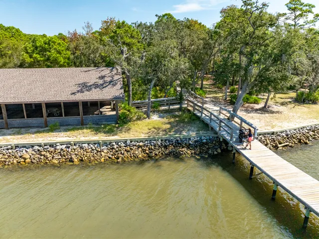 a view of a swimming pool with lawn chairs under an umbrella