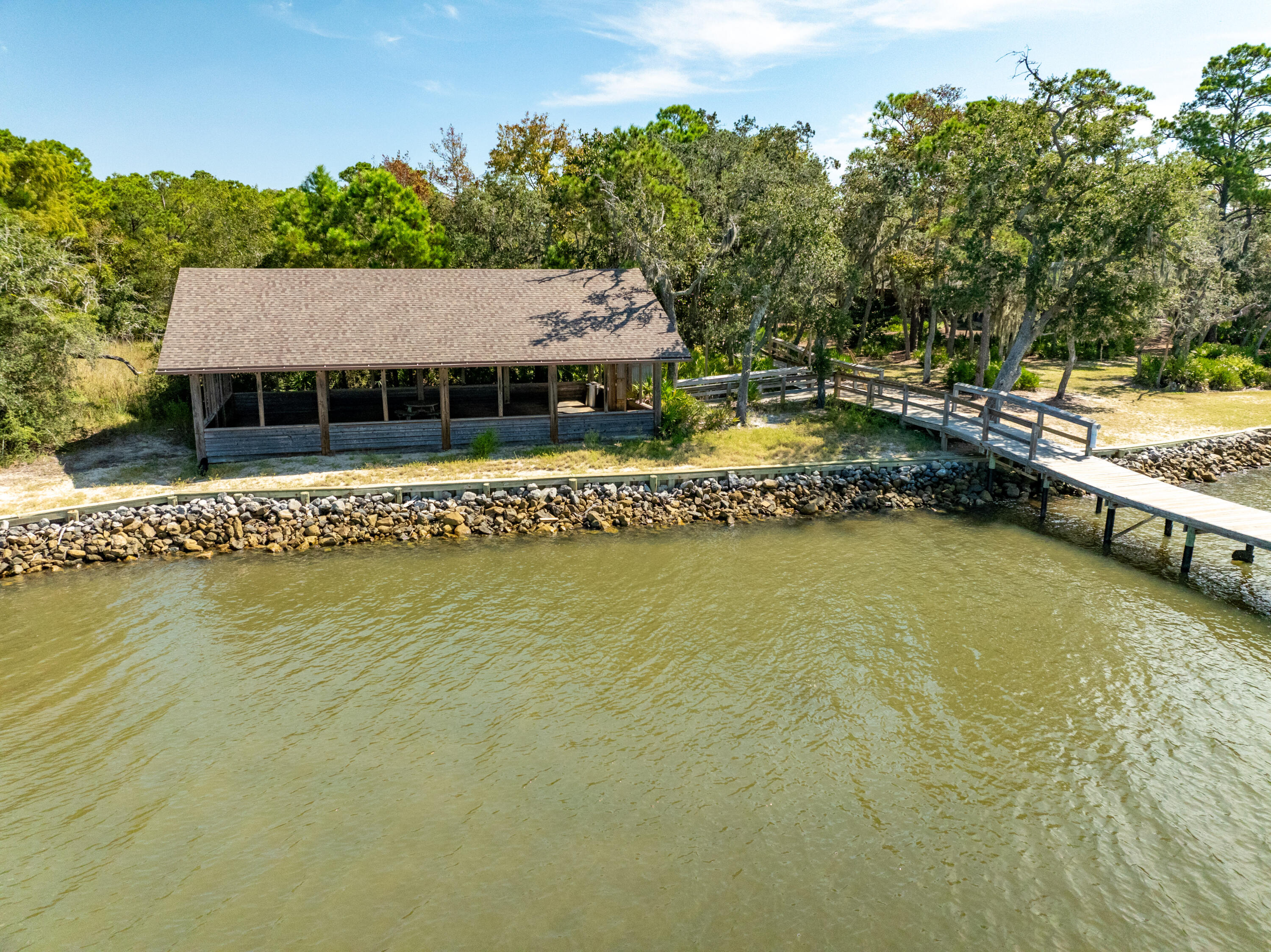 Lot 37 East Captain Fritz Way Freeport, FL 32439 - Photo 13 of 34 a view of a swimming pool with lawn chairs under an umbrella