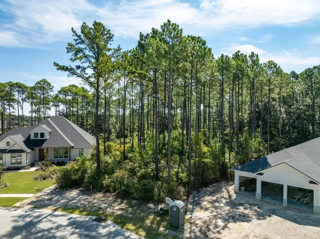 an aerial view of a house with yard and outdoor seating
