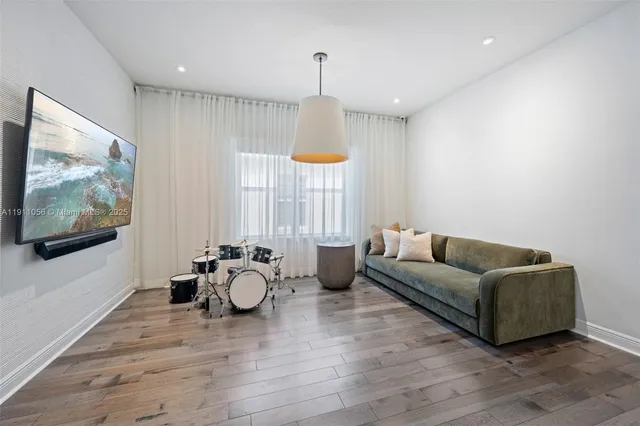 a living room with furniture window and wooden floor