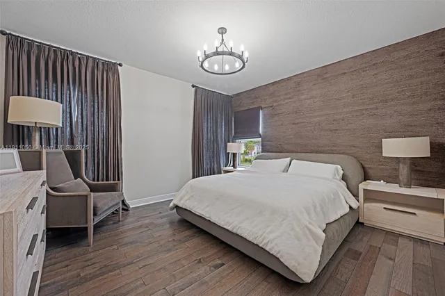 a bedroom with a bed a couch and dresser