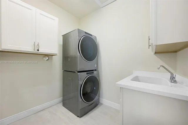 a utility room with sink dryer and washer