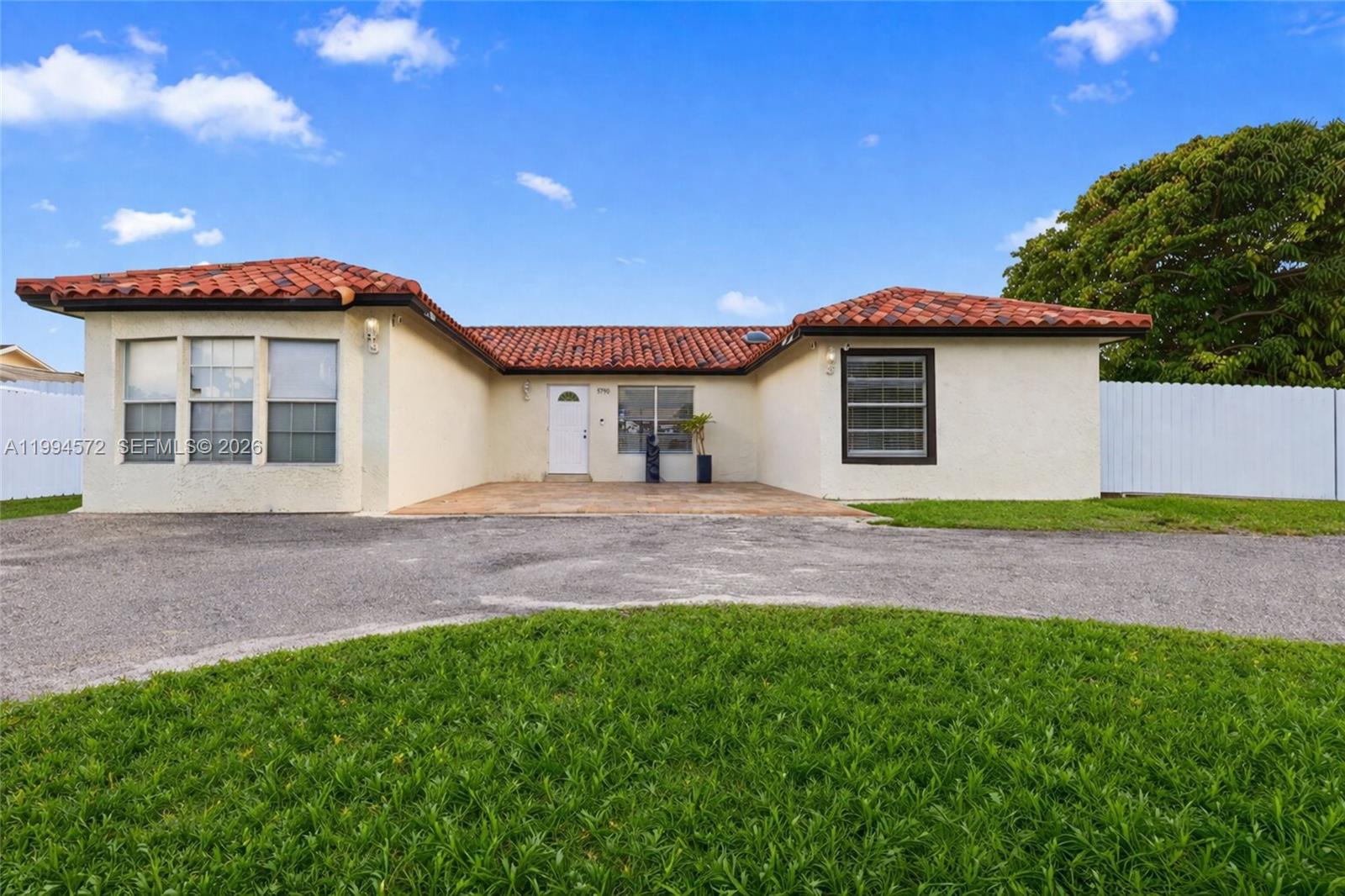 5730 Northwest 199th Street Hialeah, FL 33015 - Photo 1 of 33 a front view of a house with a garden