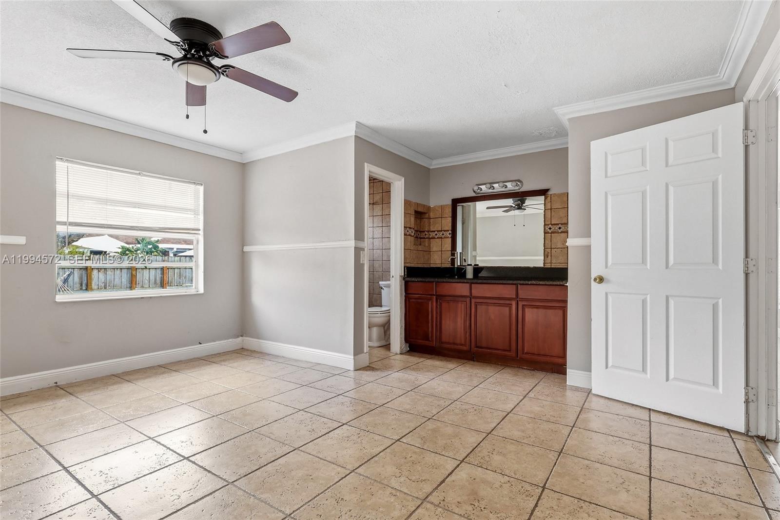 5730 Northwest 199th Street Hialeah, FL 33015 - Photo 14 of 33 a living room with a couch and a chandelier