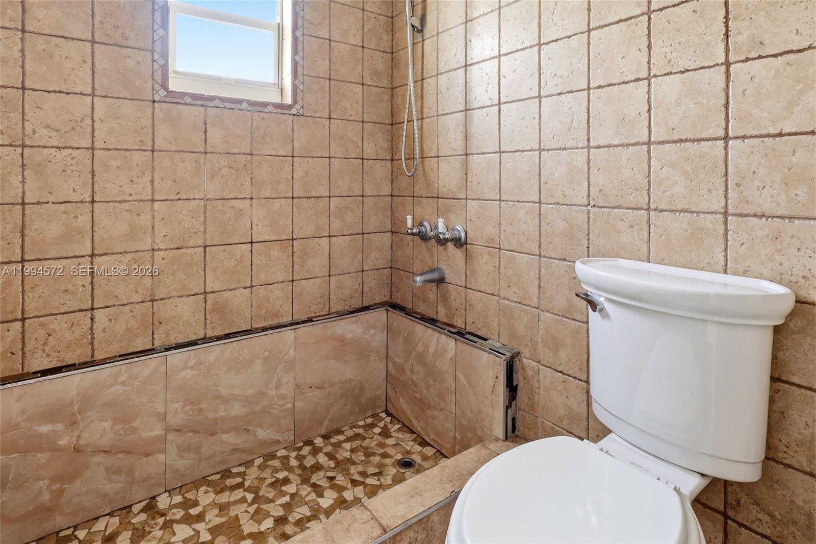 5730 Northwest 199th Street Hialeah, FL 33015 - Photo 15 of 33 a white toilet sitting next to a bathroom sink