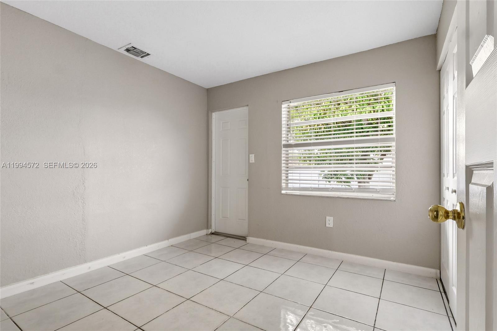 5730 Northwest 199th Street Hialeah, FL 33015 - Photo 22 of 33 a view of an empty room with a window