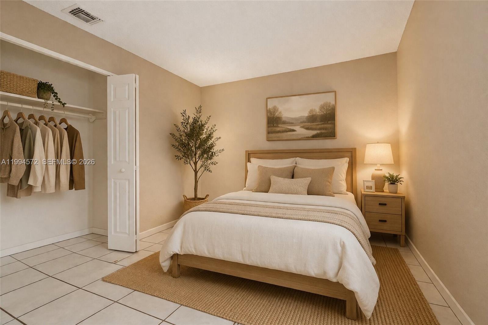 5730 Northwest 199th Street Hialeah, FL 33015 - Photo 25 of 33 a bedroom with a bed and a painting on the wall