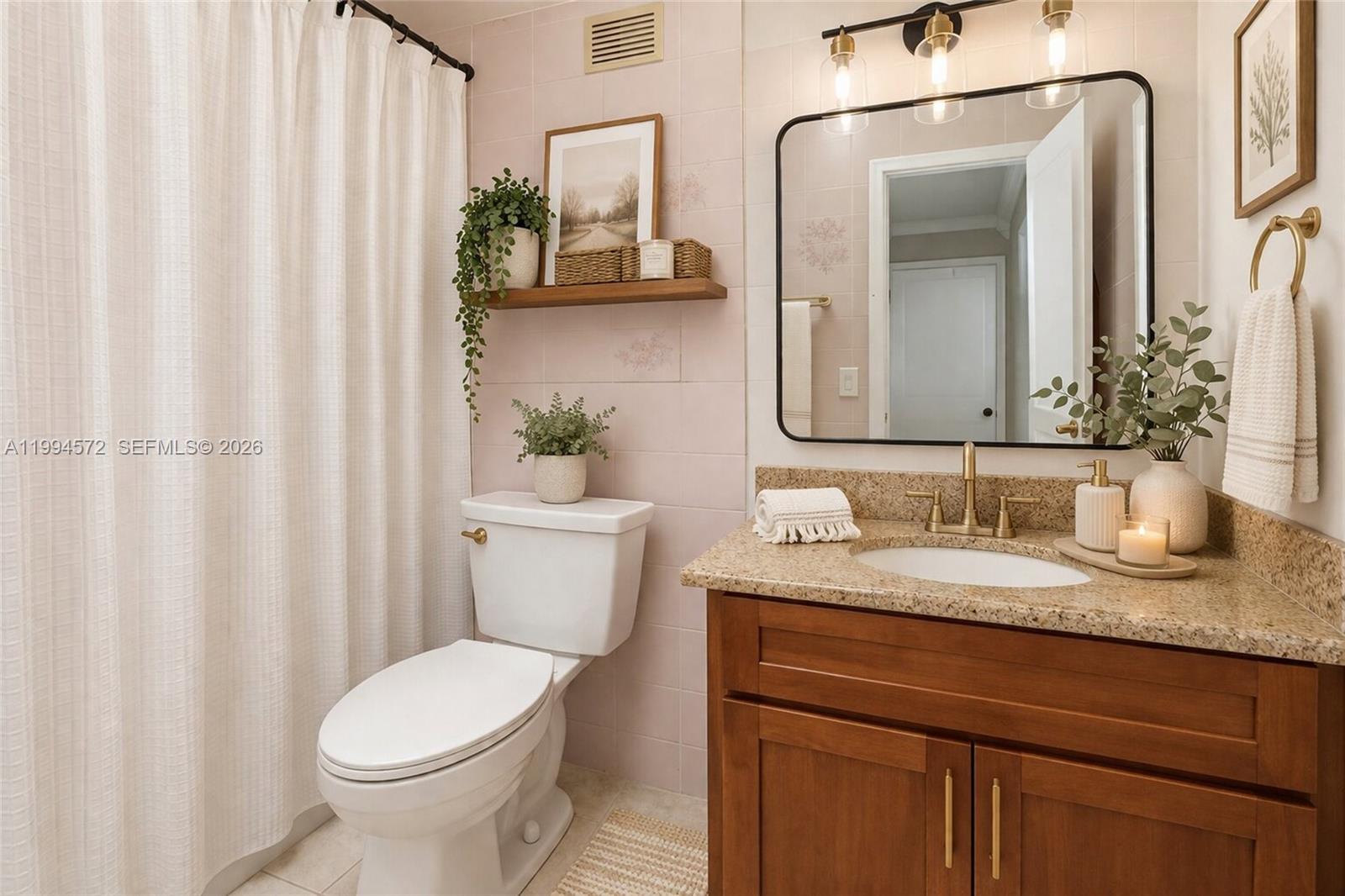 5730 Northwest 199th Street Hialeah, FL 33015 - Photo 27 of 33 a bathroom with a granite countertop sink and a mirror with toilet