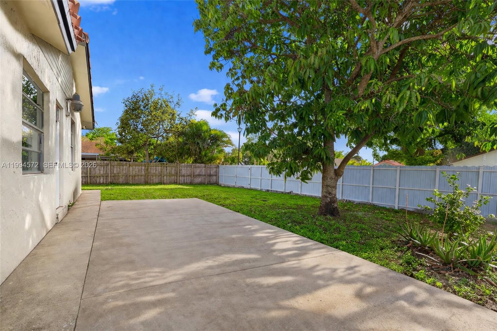 5730 Northwest 199th Street Hialeah, FL 33015 - Photo 29 of 33 a view of backyard with plants and trees
