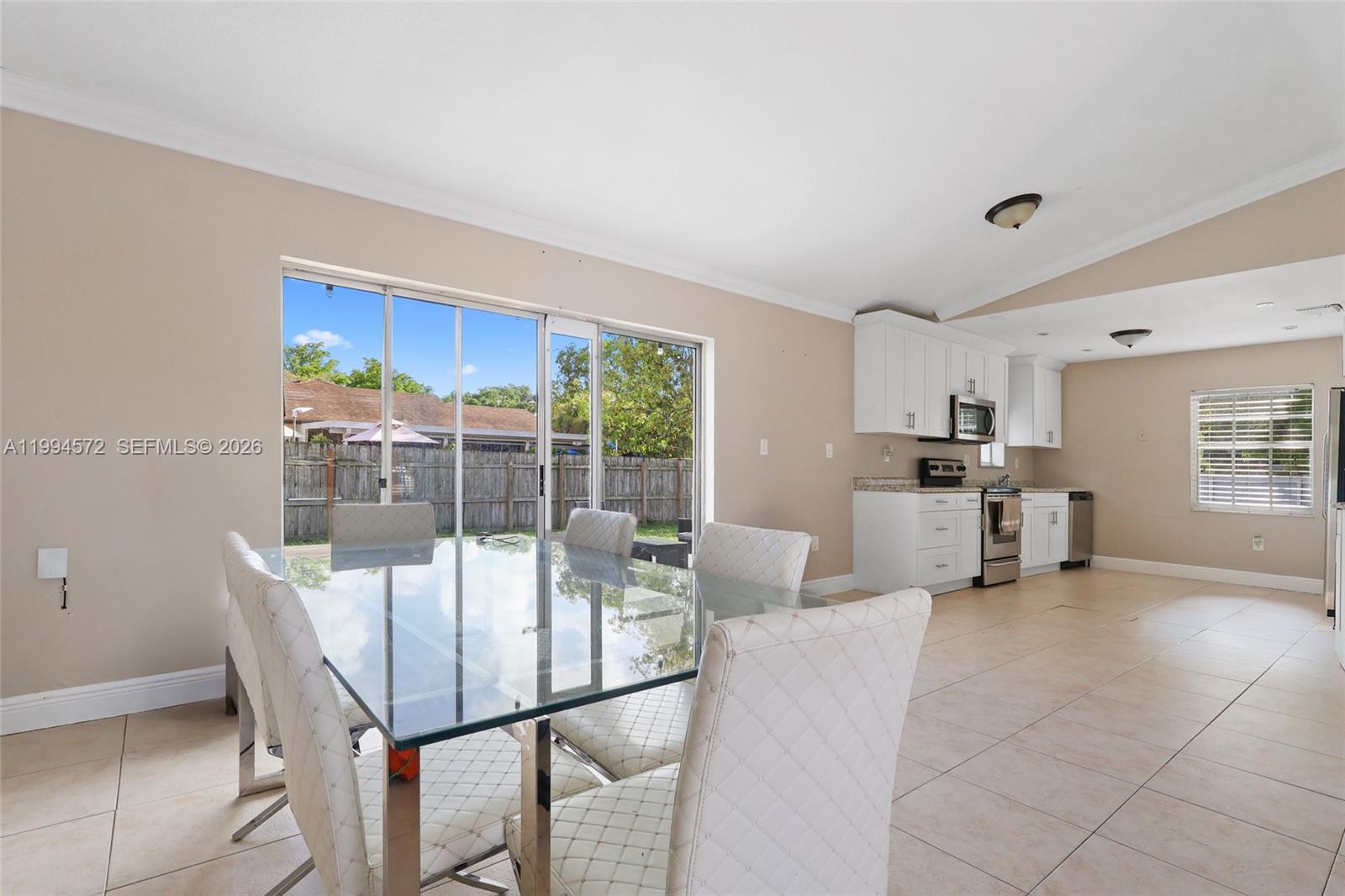 5730 Northwest 199th Street Hialeah, FL 33015 - Photo 8 of 33 a view of a dining room with furniture window and outside view