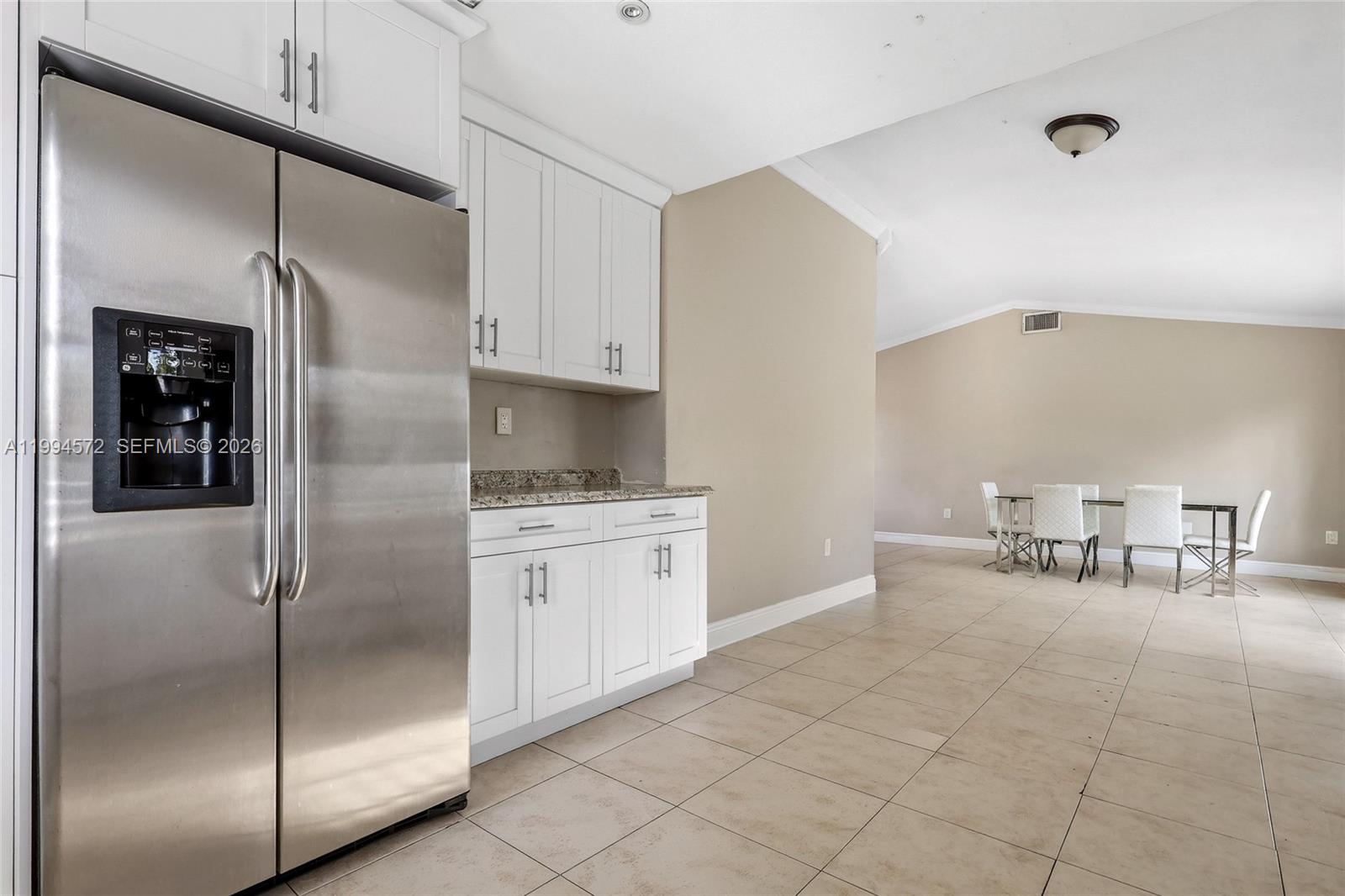 5730 Northwest 199th Street Hialeah, FL 33015 - Photo 9 of 33 a kitchen with stainless steel appliances granite countertop a refrigerator and a stove top oven