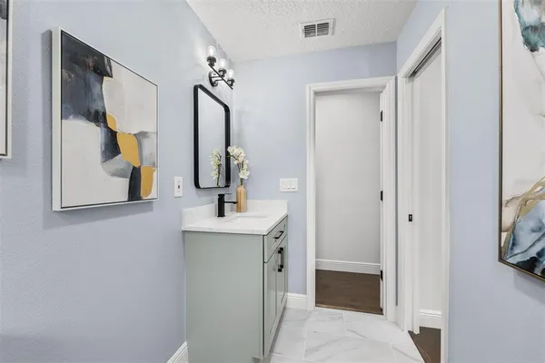 a en suite bathroom with a toilet sink and mirror