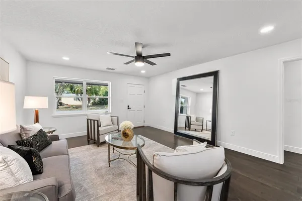 a living room with furniture a window and a table