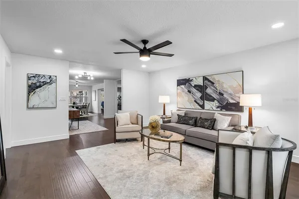 a living room with furniture and wooden floor
