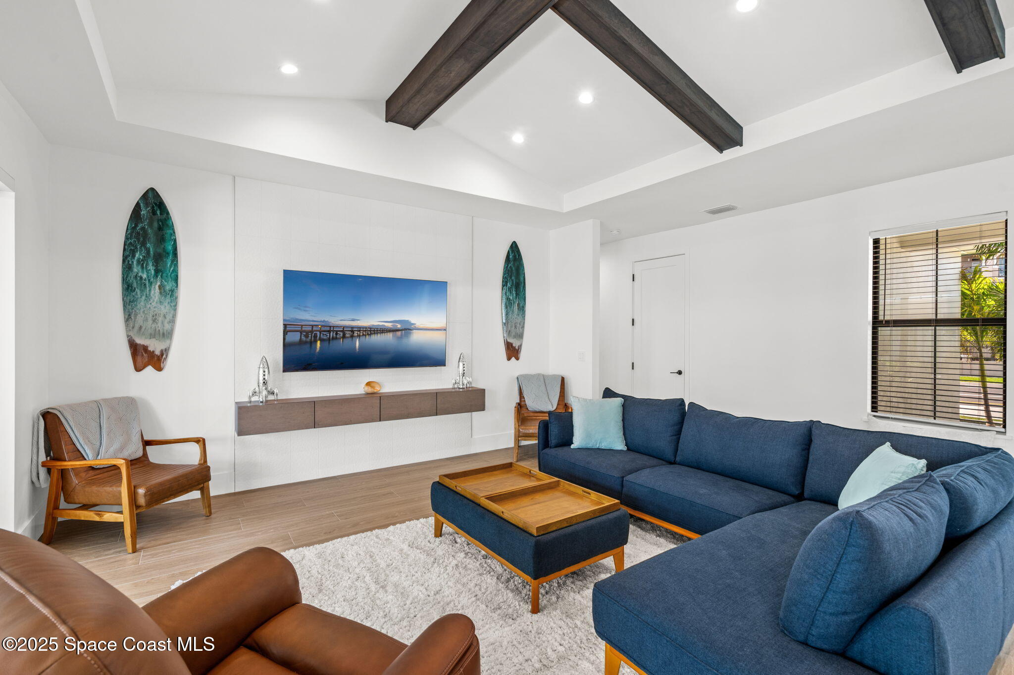 2021 South Orlando Avenue Cocoa Beach, FL 32931 - Photo 14 of 42 a living room with furniture and a flat screen tv