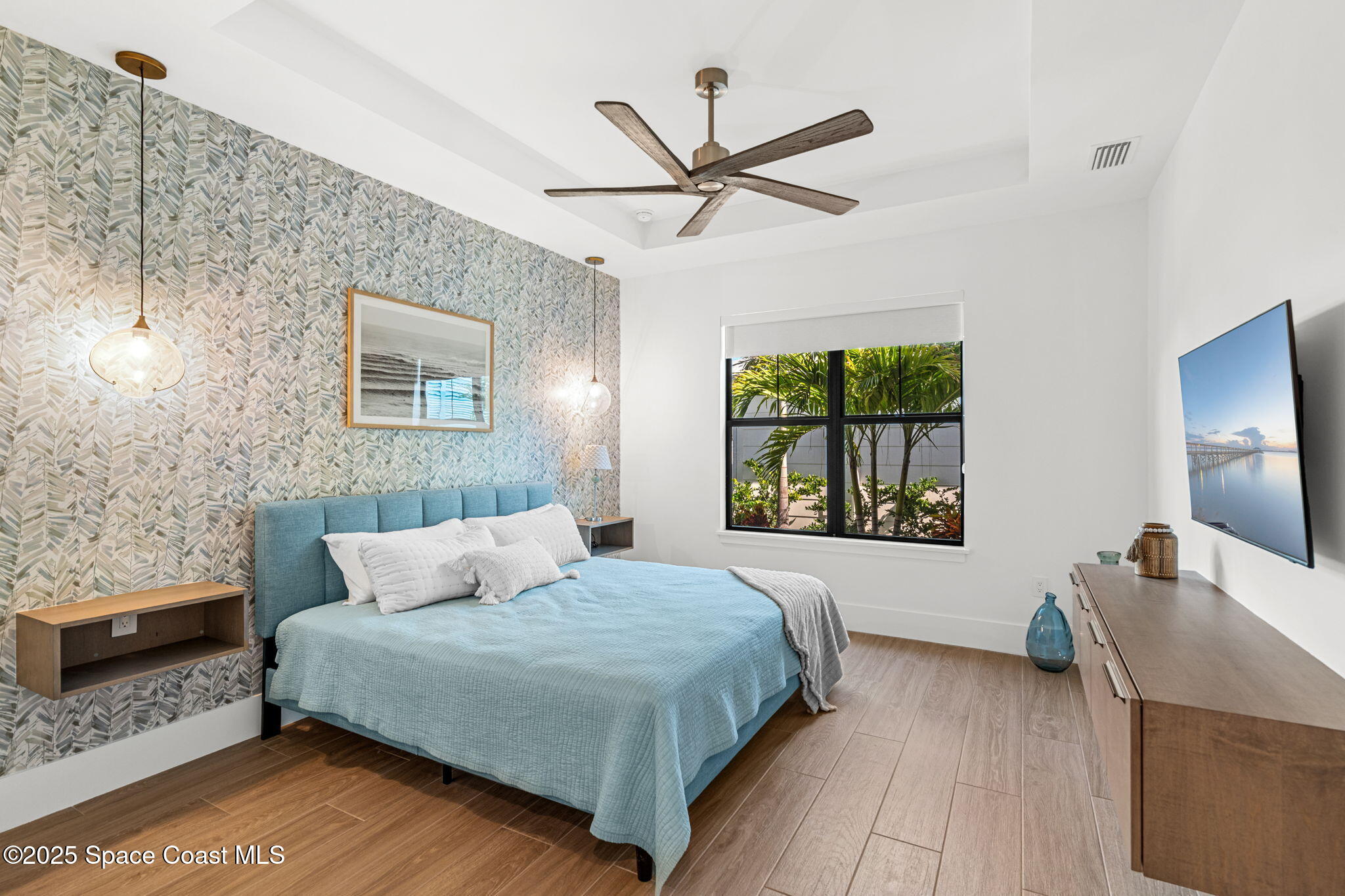 2021 South Orlando Avenue Cocoa Beach, FL 32931 - Photo 15 of 42 a bedroom with a large bed and a window