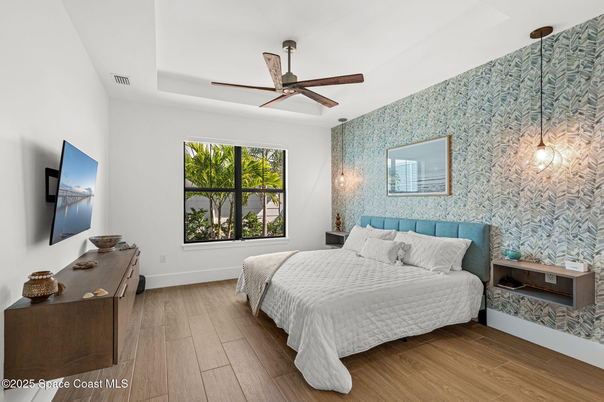 2021 South Orlando Avenue Cocoa Beach, FL 32931 - Photo 17 of 42 a bedroom with a bed and a flat screen tv