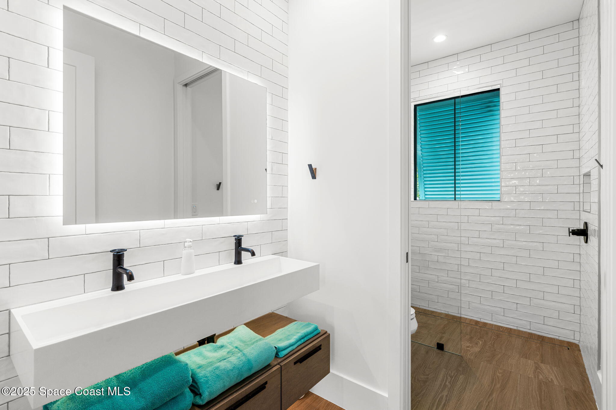 2021 South Orlando Avenue Cocoa Beach, FL 32931 - Photo 18 of 42 a bathroom with a sink and a mirror