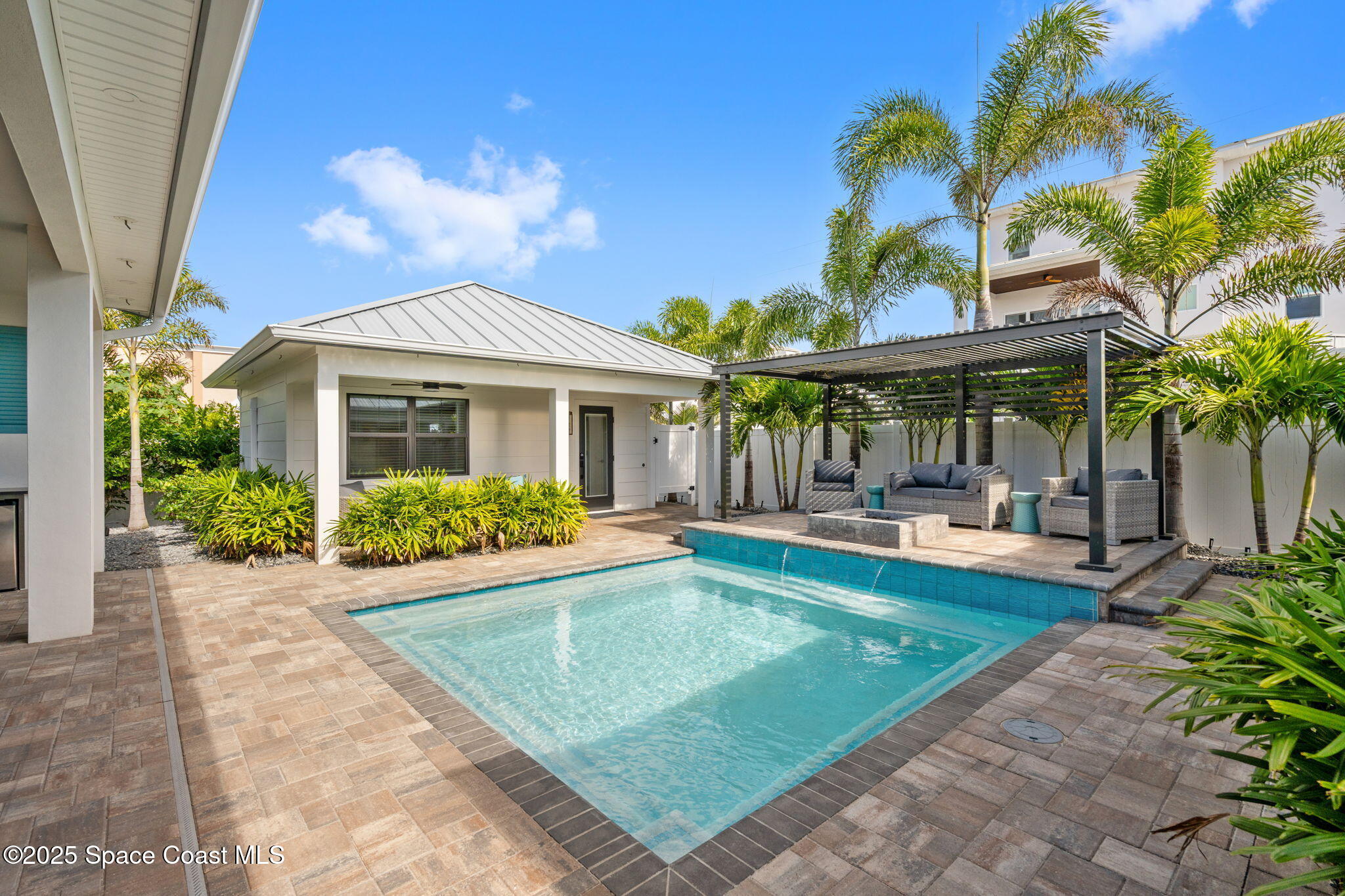 2021 South Orlando Avenue Cocoa Beach, FL 32931 - Photo 20 of 42 a view of a house with swimming pool and sitting area