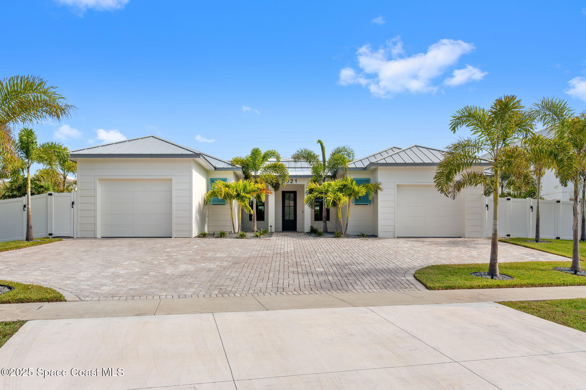 2021 South Orlando Avenue Cocoa Beach, FL 32931 - Photo 2 of 42 a front view of a house with a yard and garage