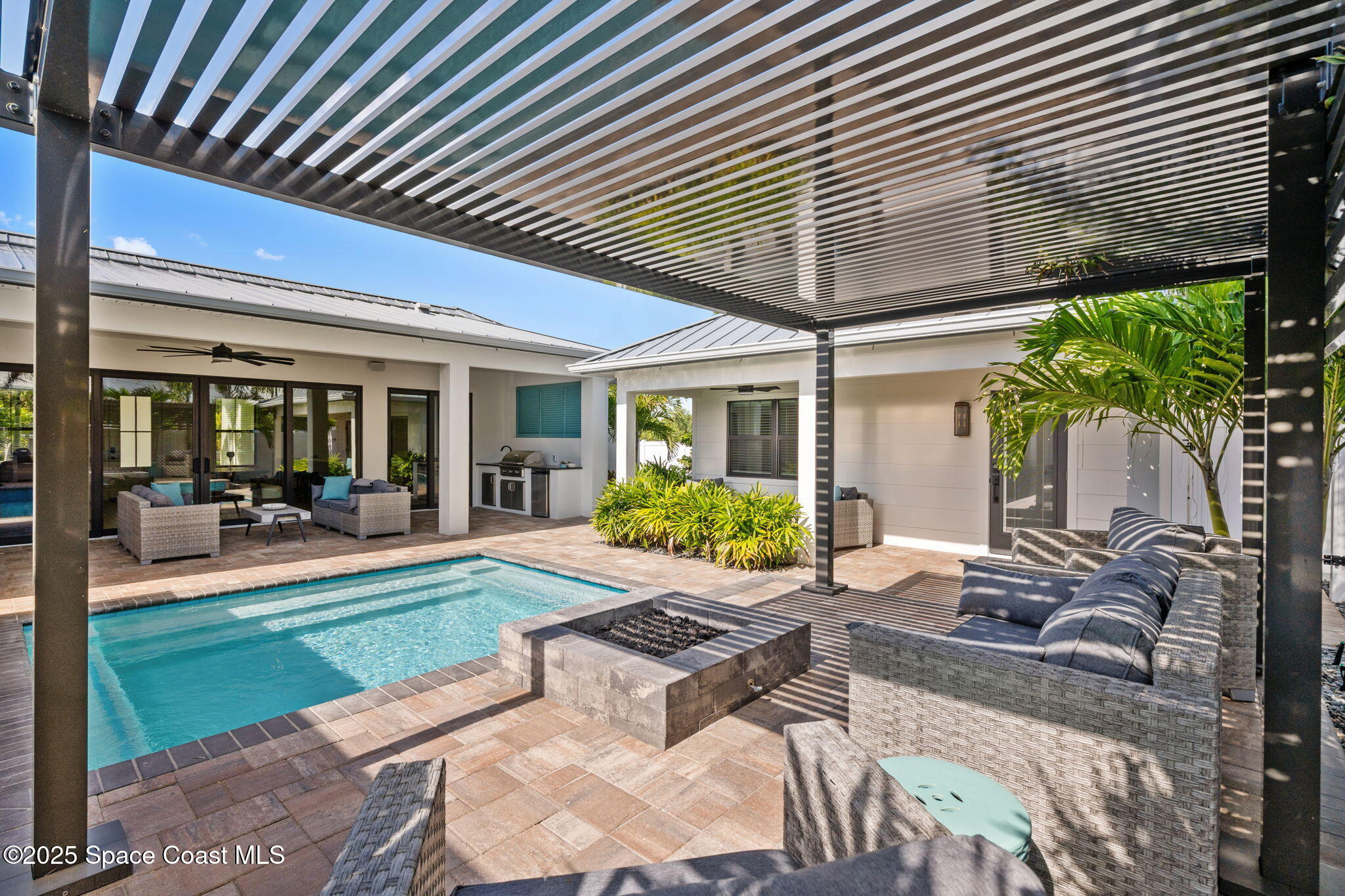 2021 South Orlando Avenue Cocoa Beach, FL 32931 - Photo 21 of 42 a view of a backyard with plants and patio