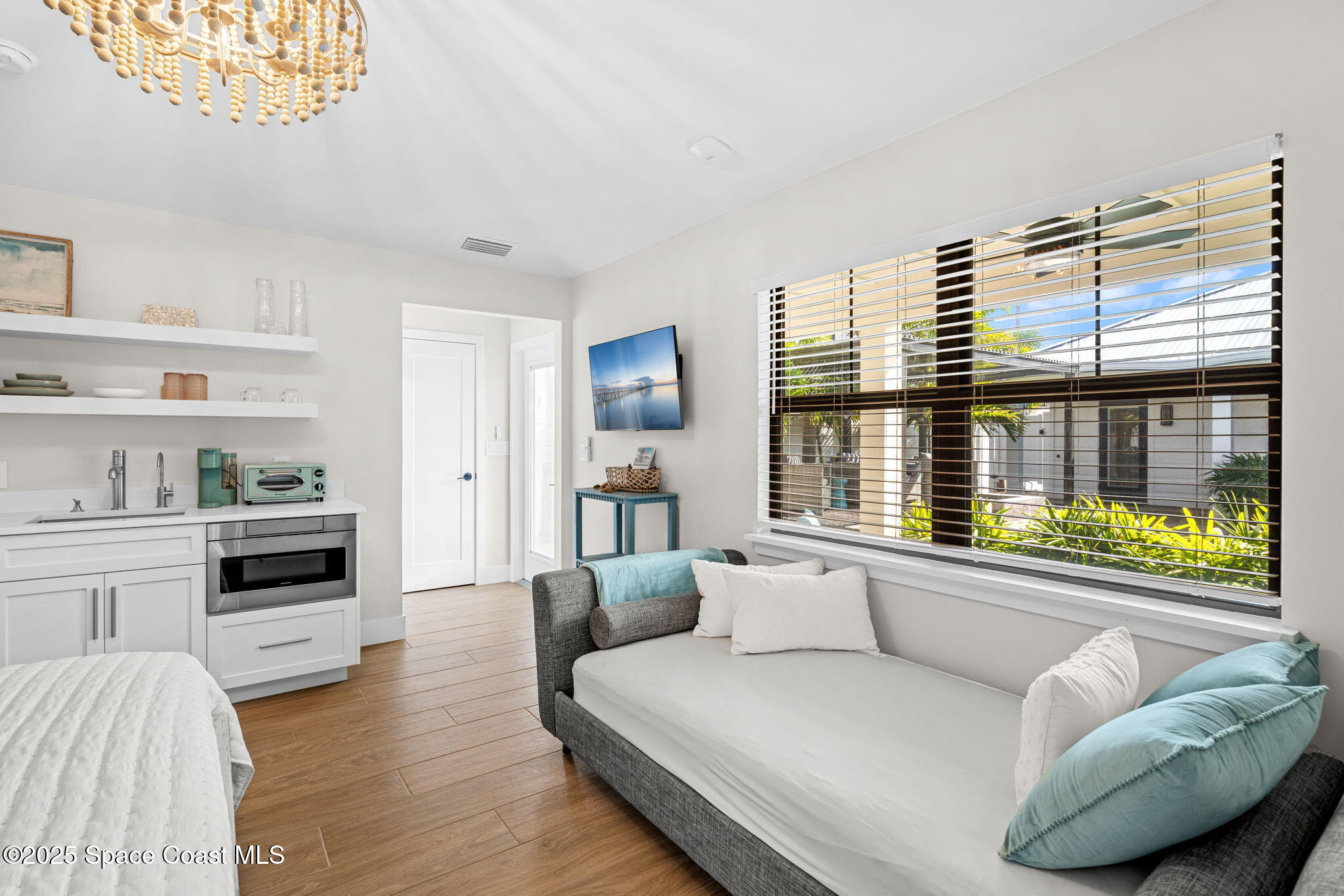 2021 South Orlando Avenue Cocoa Beach, FL 32931 - Photo 22 of 42 a living room with furniture and a large window