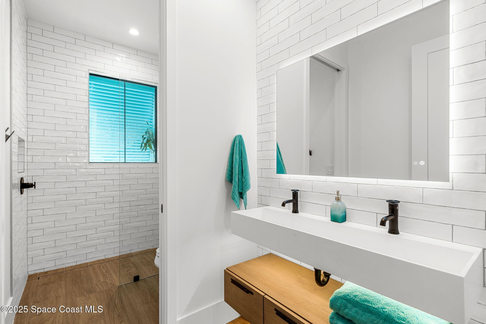 2021 South Orlando Avenue Cocoa Beach, FL 32931 - Photo 23 of 42 a bathroom with a sink and a mirror