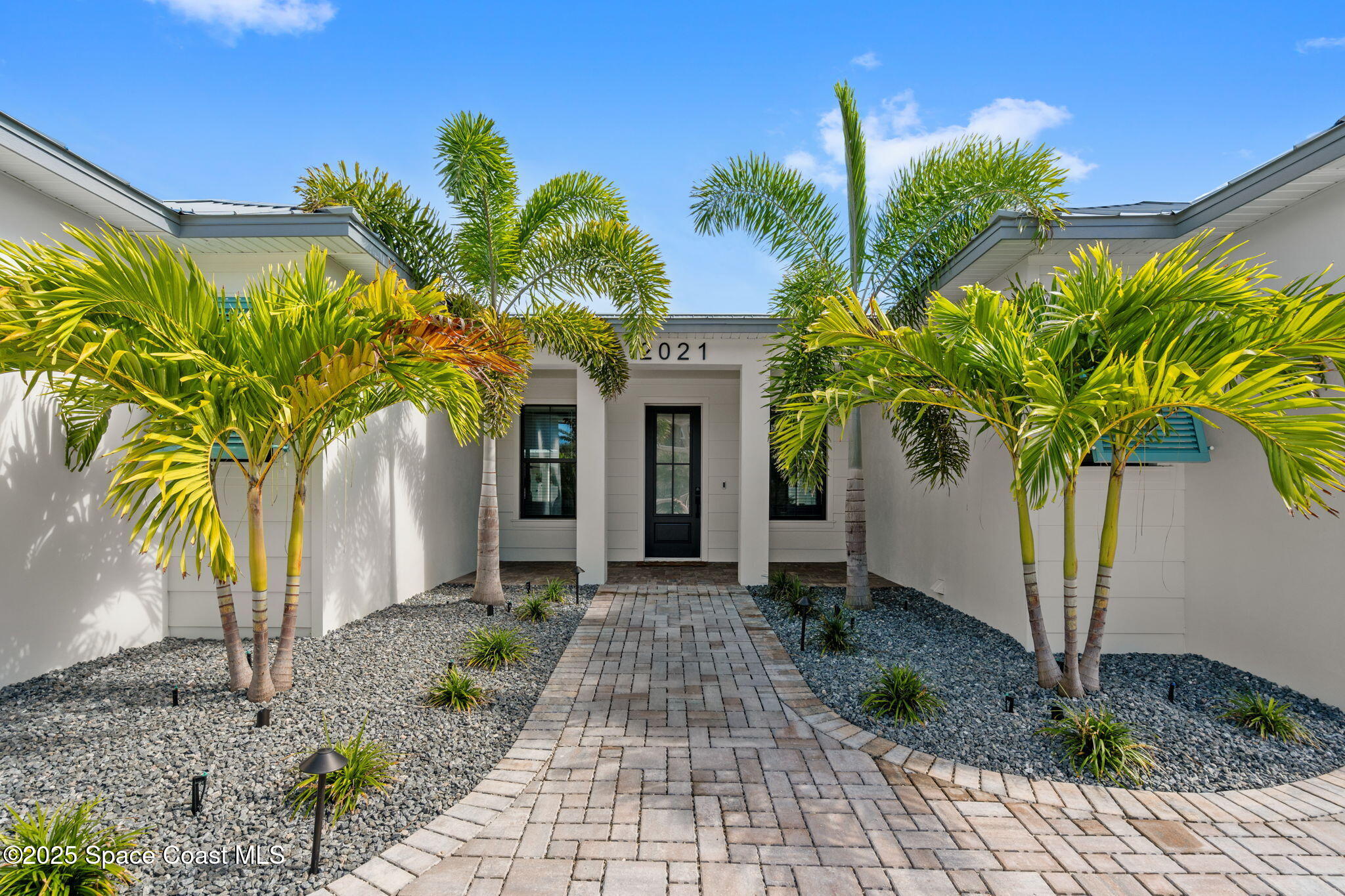2021 South Orlando Avenue Cocoa Beach, FL 32931 - Photo 3 of 42 a front view of yellow house with a porch
