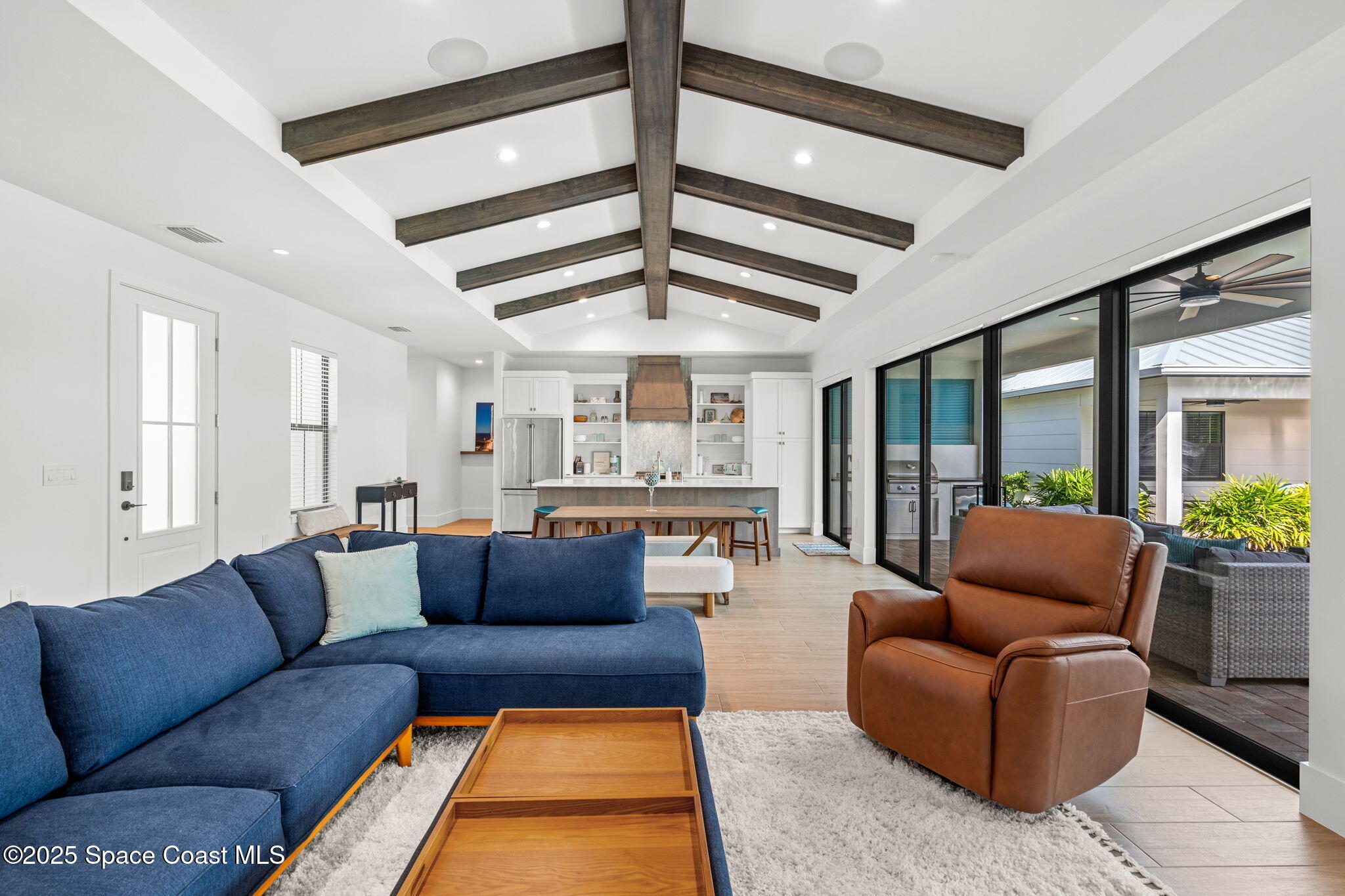 2021 South Orlando Avenue Cocoa Beach, FL 32931 - Photo 6 of 42 a living room with furniture ceiling fan and a rug