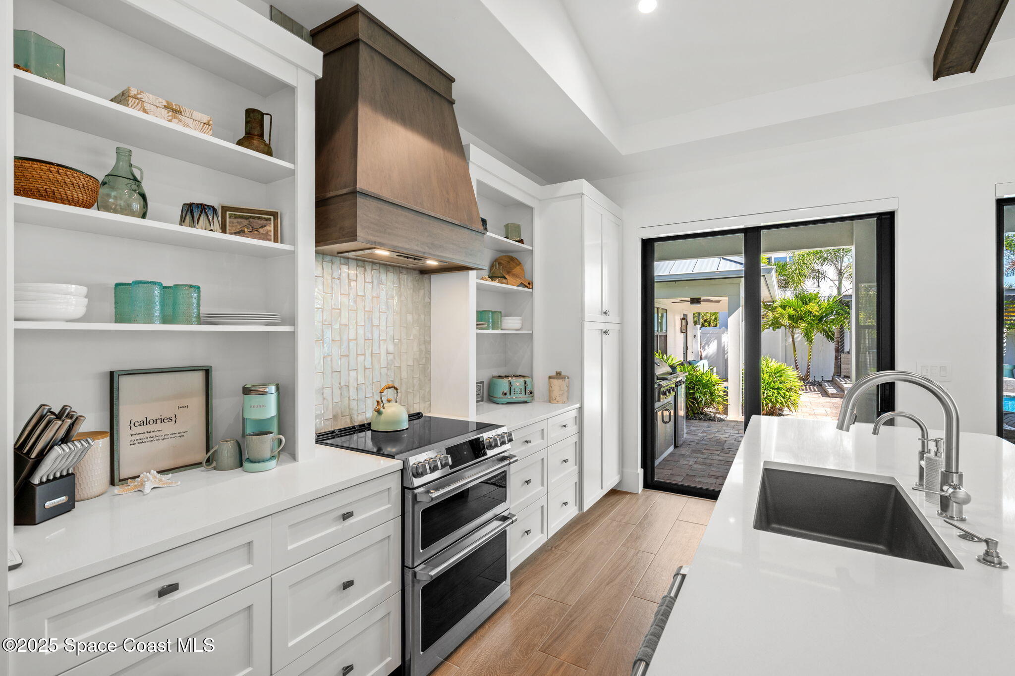 2021 South Orlando Avenue Cocoa Beach, FL 32931 - Photo 9 of 42 a kitchen with stainless steel appliances a sink stove and cabinets